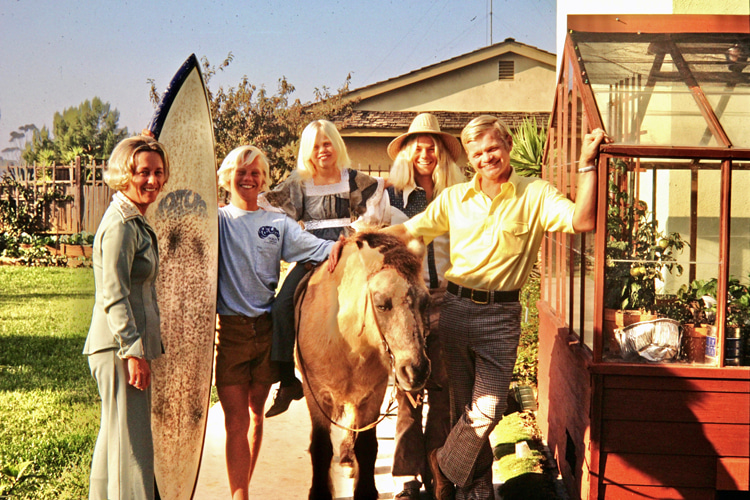 Buran family photo, 1975: my dad, mother, brother Phil, and sister Barbie. Phil was a mid-70s hippie, a straight-A student, and a good surfer in his own right. Barbie also surfed, had reasonable success in competition, and often tagged along with me and the Carlsbad boys on surf adventures. The board I'm holding was the first I received from my original sponsor, Midget Smith. By this time, my bedroom walls were covered in surf photos, and my surf dreams had no limits | Photo: Buran Archive